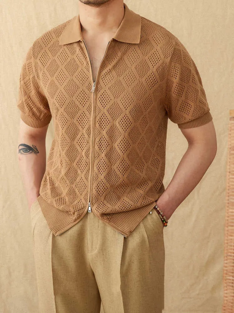 Light brown short sleeve cotton cardigan with a front zipper and lapel collar laid flat.