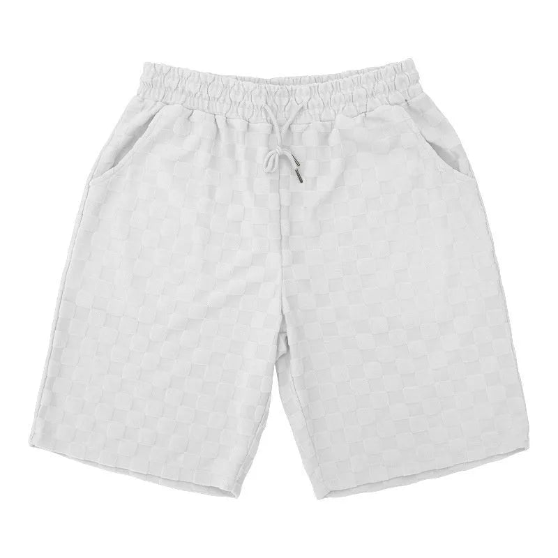 Man's loose-fit checkerboard plaid sports shorts in polyester, shown in multiple colours.