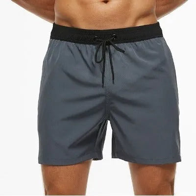 Men's blue stitching waist training shorts with zipper pockets and a drawstring, laid flat.