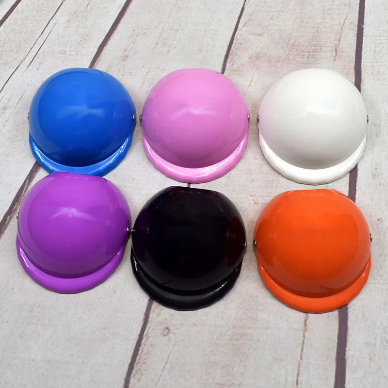 A pink plastic dog hat designed like a motorcycle helmet on a white background.
