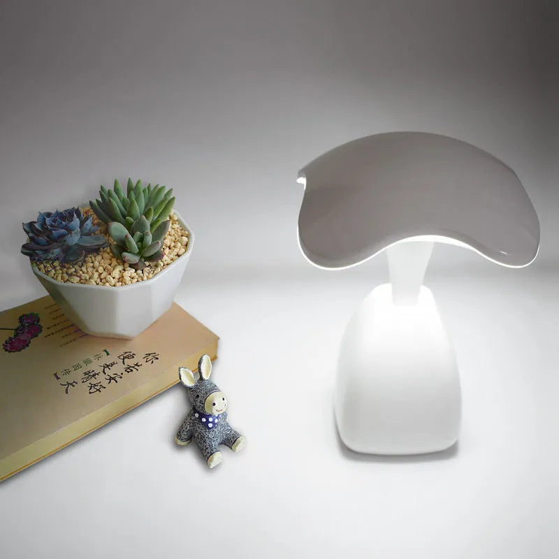 White modern LED desk lamp with plastic shade and touch controls on wooden desk