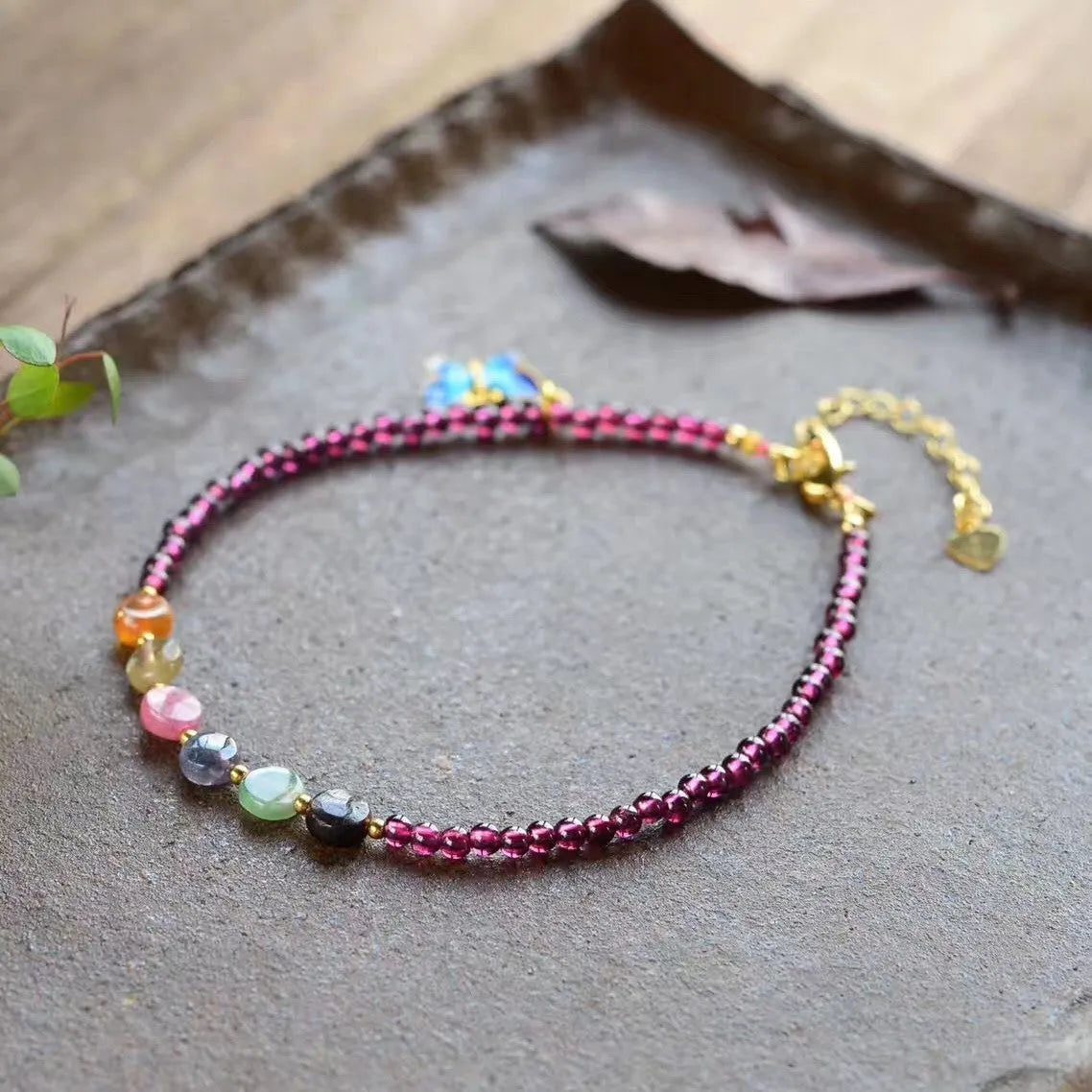Purple garnet stone bead geometric anklet on an adjustable metal chain.