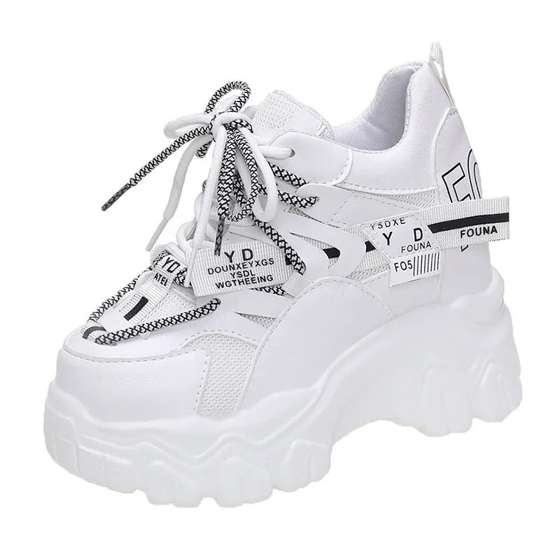 Women's white and black breathable mesh platform sports shoes with cross-strap and rubber sole.