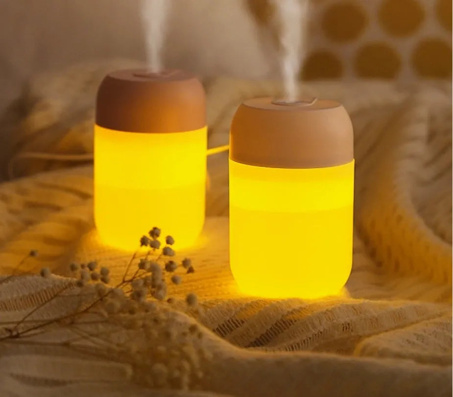 Small white cylindrical USB mini humidifier for desk or bedside use.