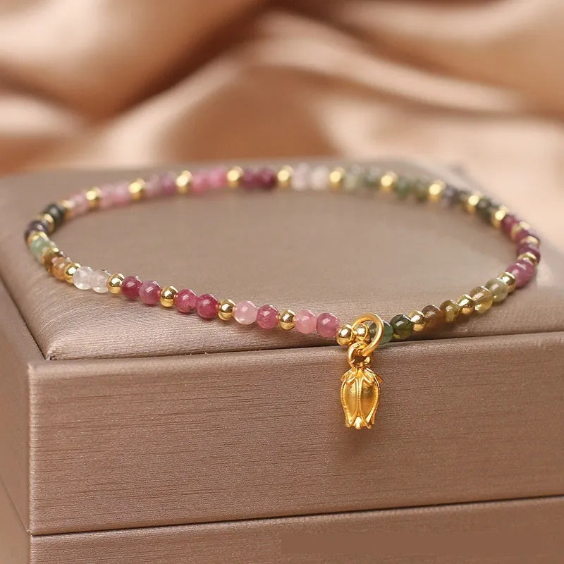 Natural tourmaline beaded anklet with flower-shaped stones on a delicate chain for women
