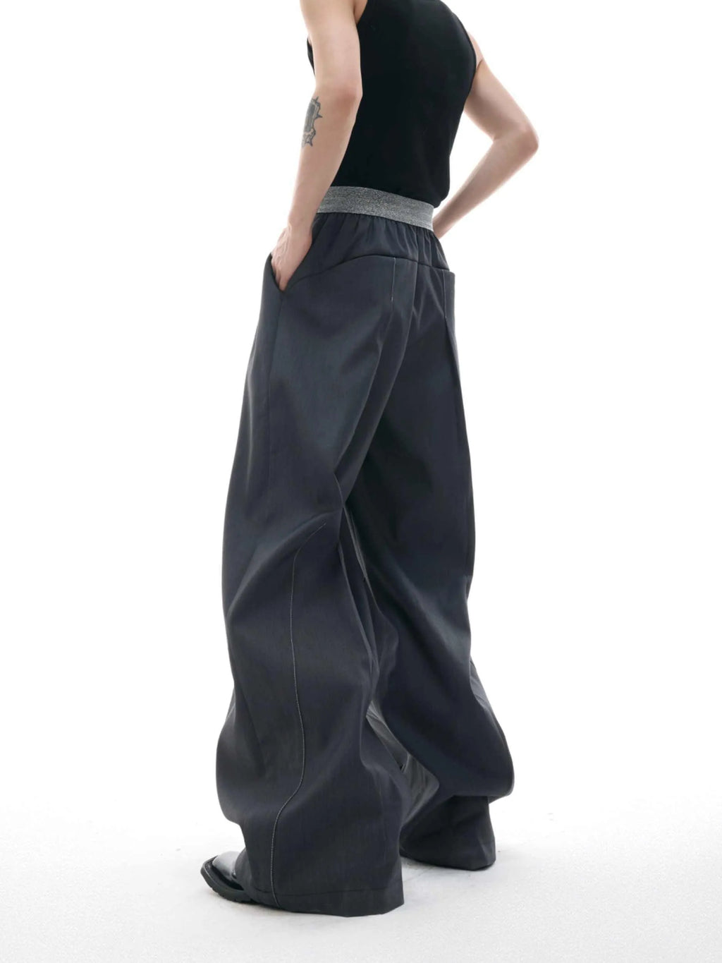 A pair of high-waisted straight-leg casual trousers in a black polyester-cotton blend with a button fly and open hem.