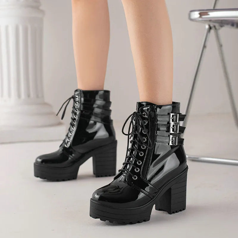 Women's black thick-heeled short boots with lace-up front and round toe on a rubber sole.