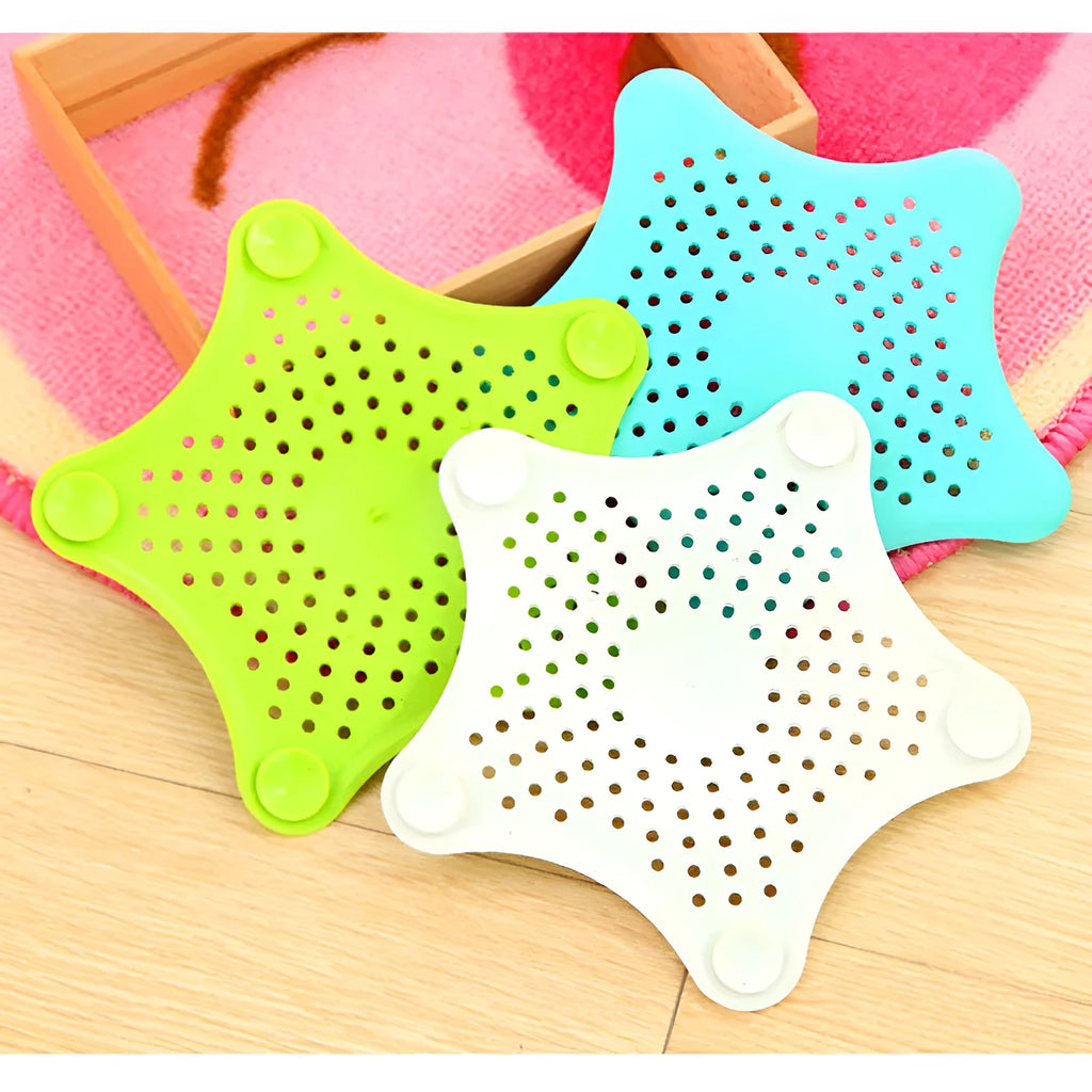 Three silicone starfish-shaped sink drain filters in white blue and green with suction cups
