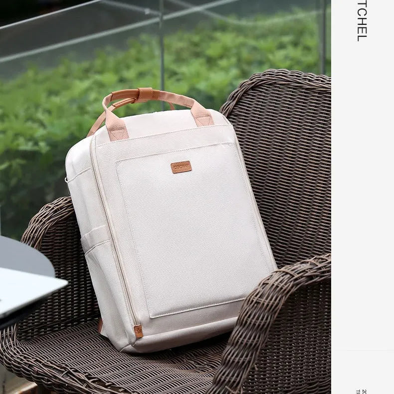 Unisex nylon backpack in black or creamy-white with curved shoulder strap and 20-35L business travel capacity