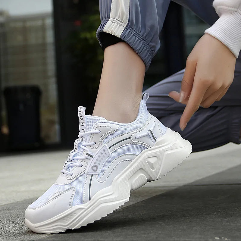 Women's thick-soled casual sports shoes with mesh upper and buckle detailing in black colour