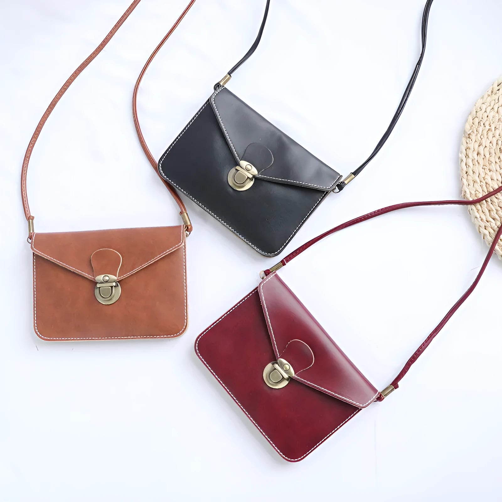 Soft surface crossbody messenger bag with flap closure and lock hardware in wine red colour