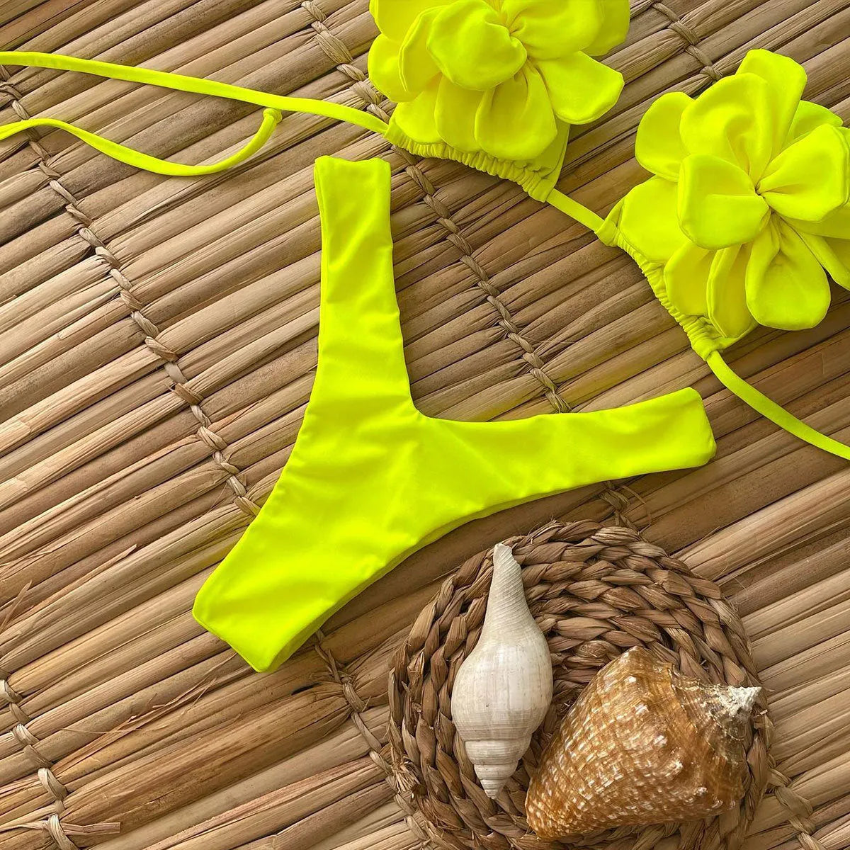 Low waist bikini swimsuit with 3D flower design in solid colour.