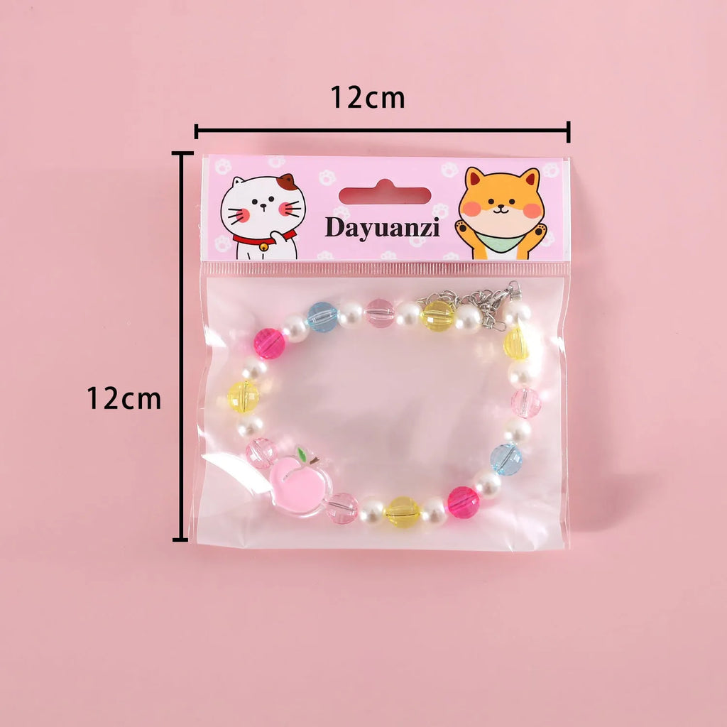 Colourful plastic bead pet necklace for small cats and dogs in peach, rainbow, and small flower designs.
