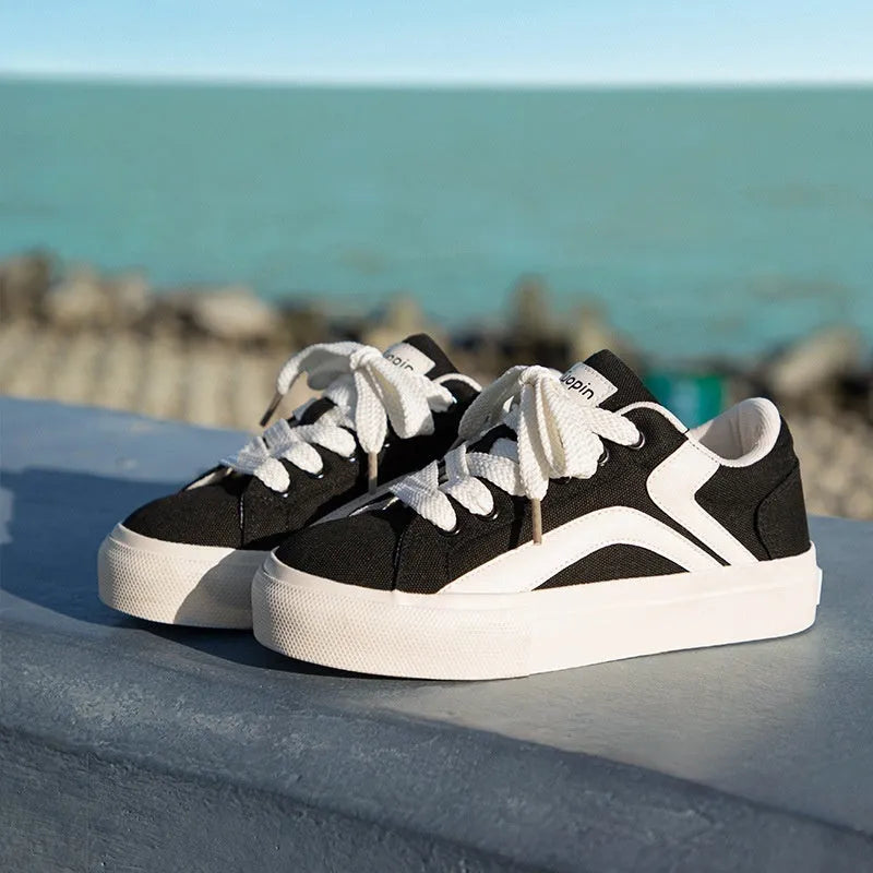 Women's blue and white vulcanised board shoes with a low-top lace-up design and round toe.