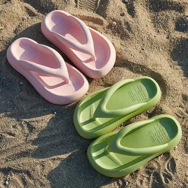 A pair of solid colour thick-soled EVA flip-flops with a bow detail, shown on a light background.
