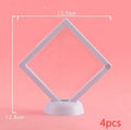 3D floating display case holding coins and jewellery between transparent membrane sheets