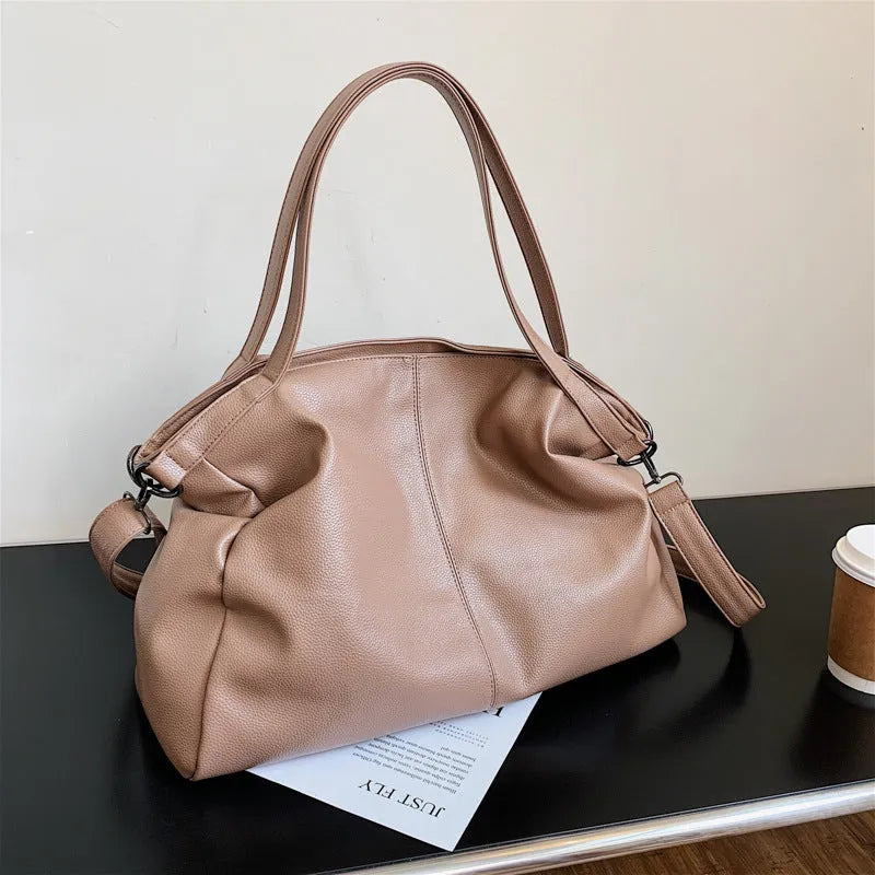 Soft surface PU leather messenger tote bag in a horizontal square shape with an adjustable shoulder strap.