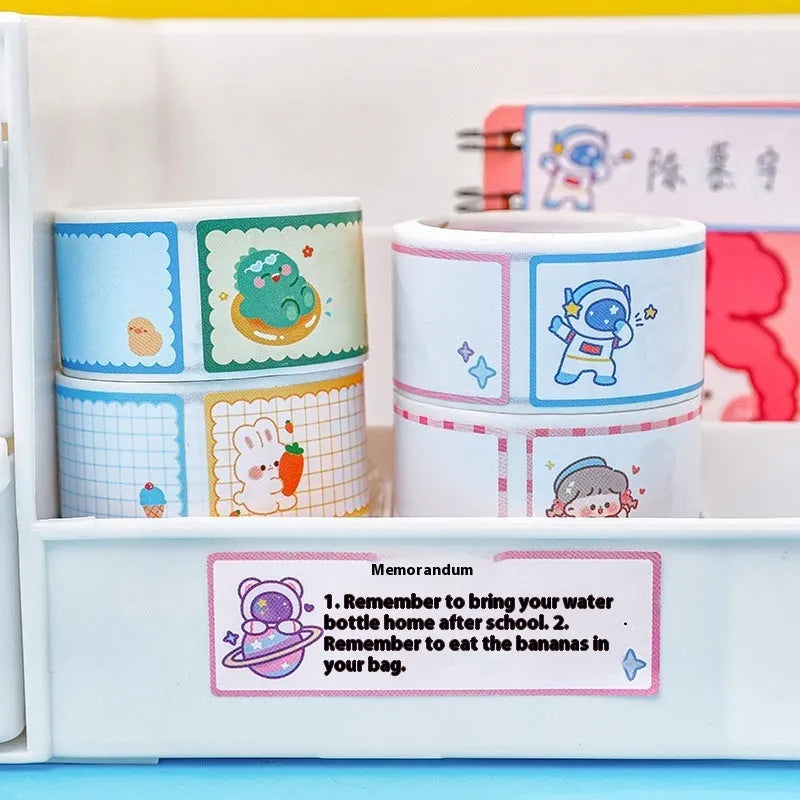 Roll of cartoon tape name stickers showing dinosaur, astronaut, rabbit, and girl designs with 60 stickers