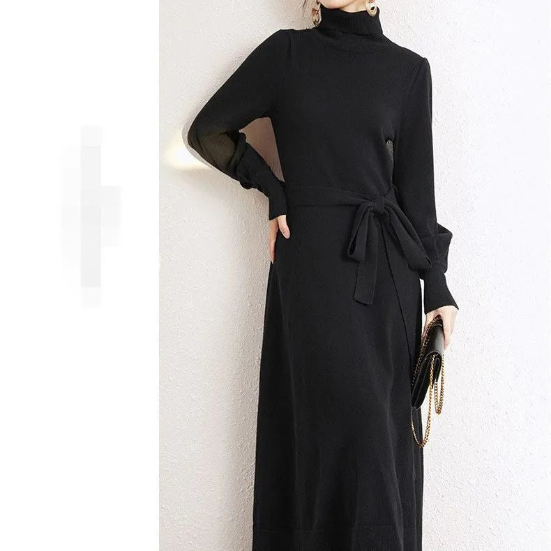 Rose red loose turtleneck knit dress with long sleeves and a flared skirt hem on a hanger.