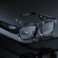 Black head-mounted smart glasses with a video recorder, showing touch controls on the frame.