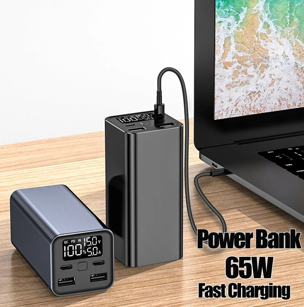 A black 65W high power laptop charging bank with a metal case, showing its dimensions.