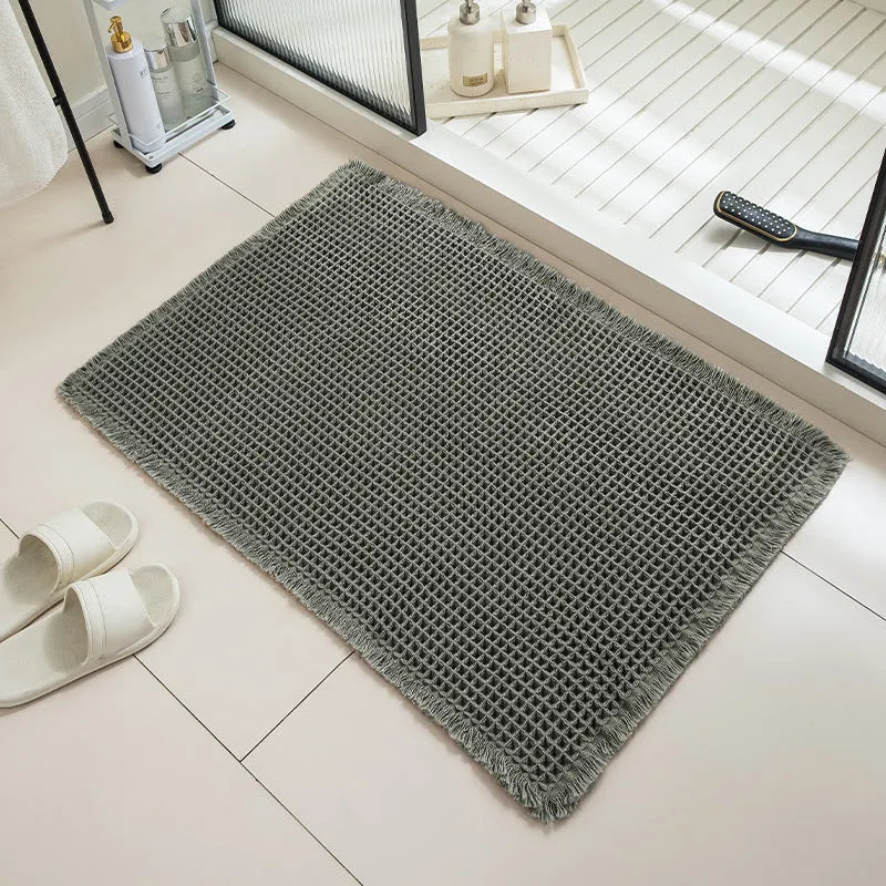 Checkered pattern non-slip absorbent bathroom floor carpet in beige colour.