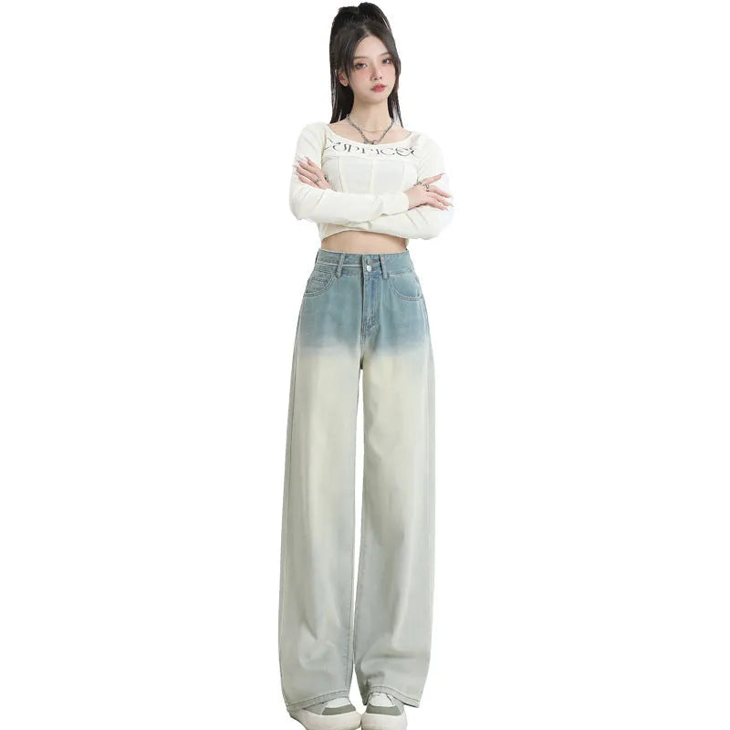 Gradient blue straight-leg denim trousers for women on a hanger, showing the wide-leg cut and colour fade.