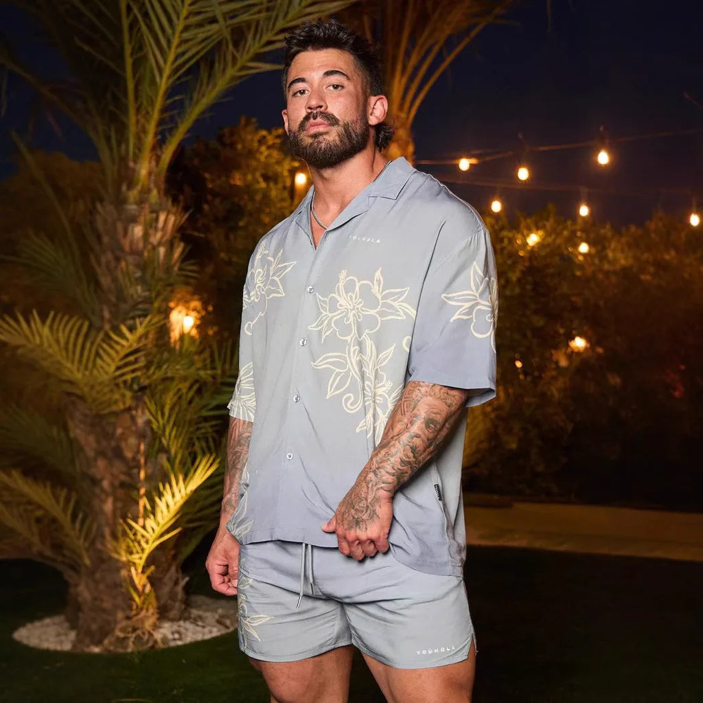 Man's loose-fitting short sleeve cardigan top with a floral print in light colours.