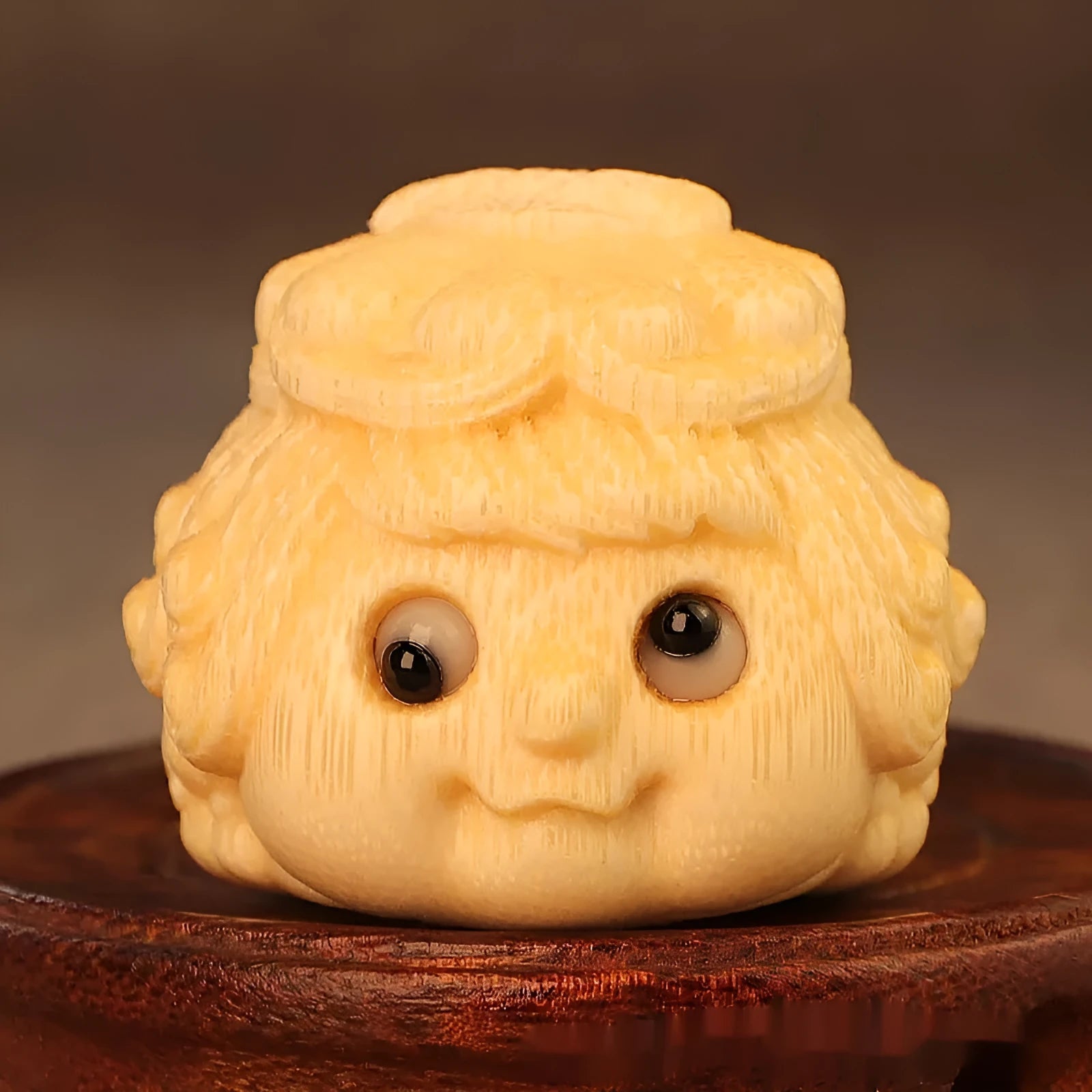 Solid bamboo carving of a cute golden toad princess ornament, 5 cm tall, on a plain background.