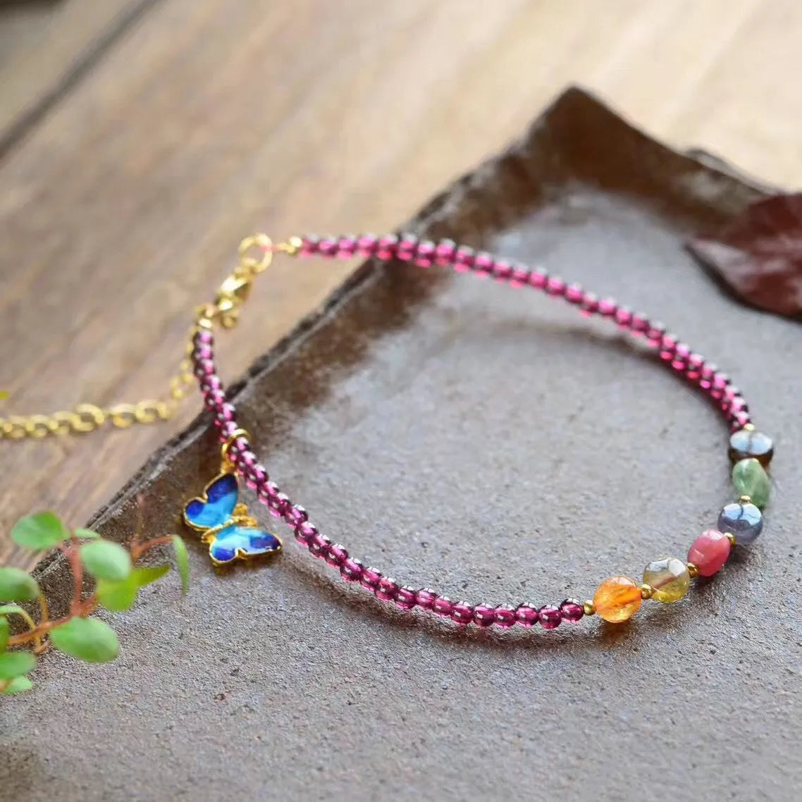 Purple garnet stone bead geometric anklet on an adjustable metal chain.