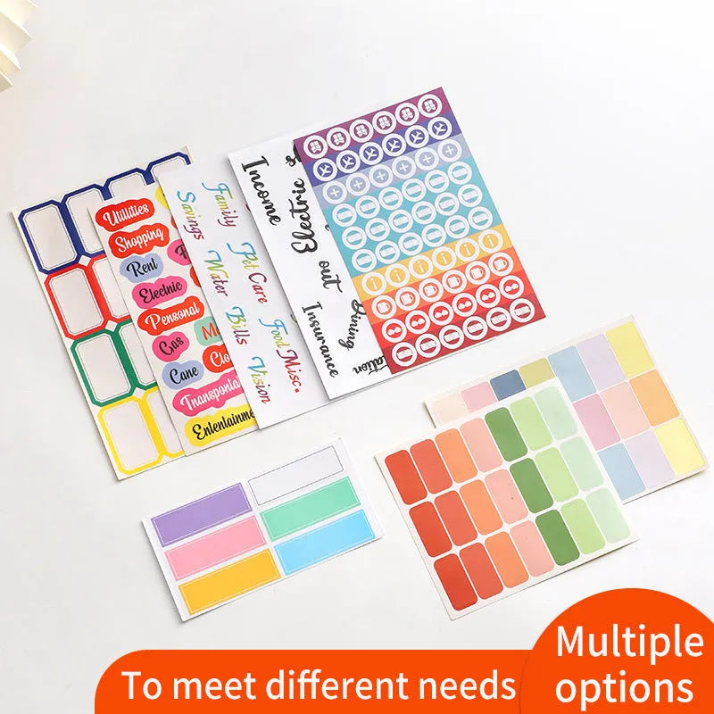 Assortment of handwritten labels, grid stickers, A6 rulers, and coloured sticky notes on a white background.