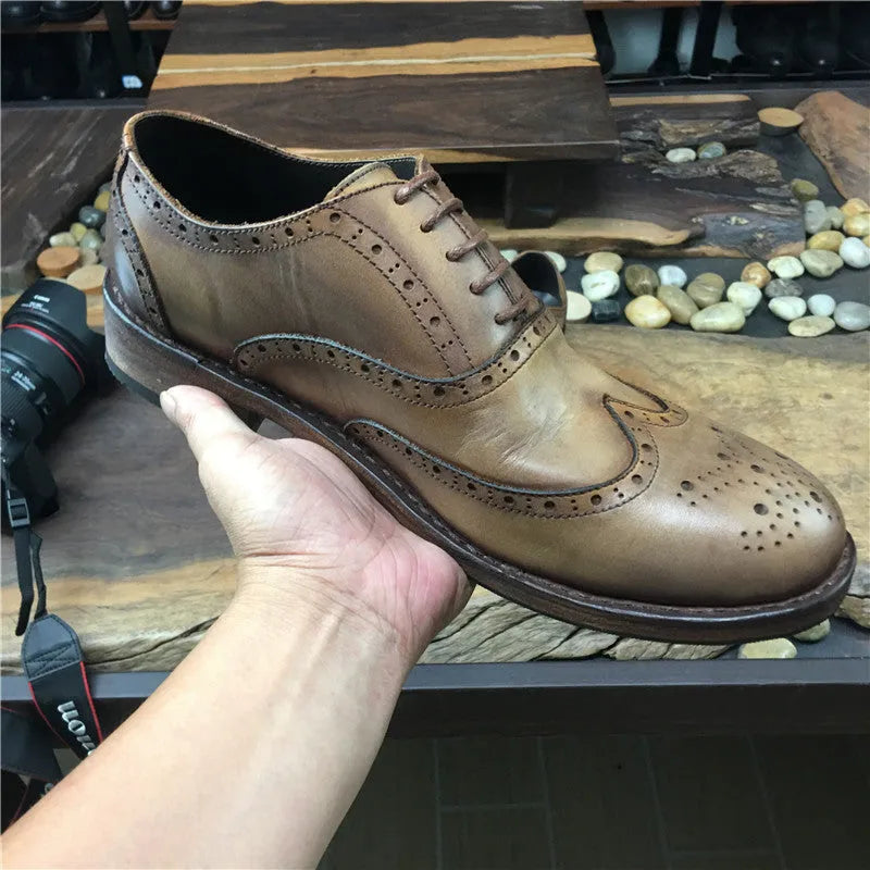 Men's light brown distressed leather lace-up shoes with engraved carving details on the upper.