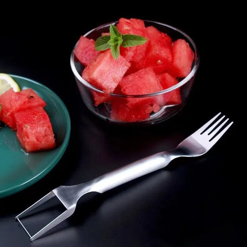 Stainless steel watermelon slicer and fork tool on a kitchen surface