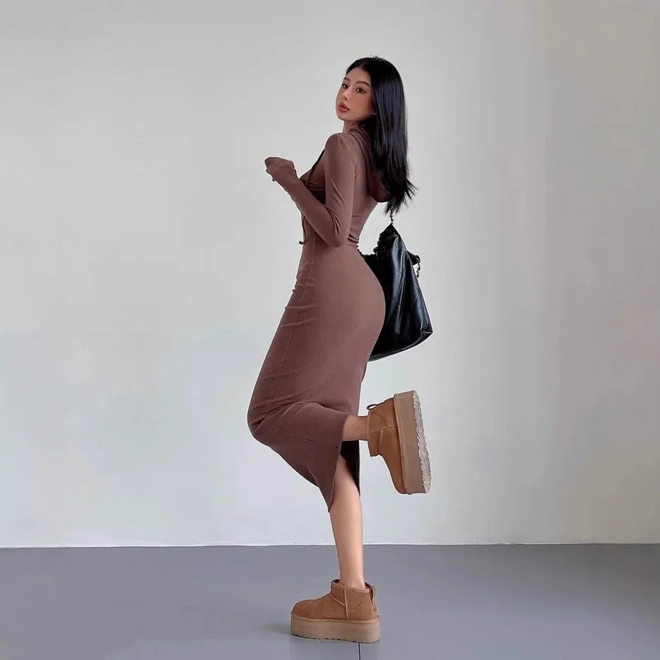 A light grey women's hooded sheath dress with long sleeves and a high waist on a model.