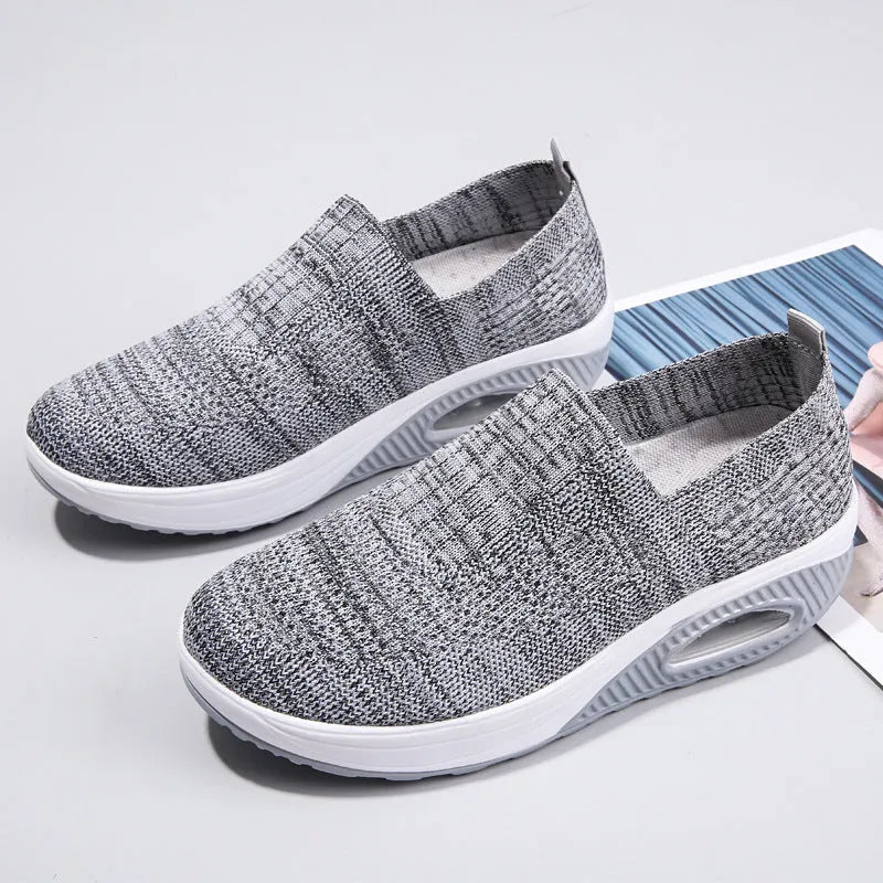 Women's beige casual running shoes with mesh upper and air cushion sole on a white background.