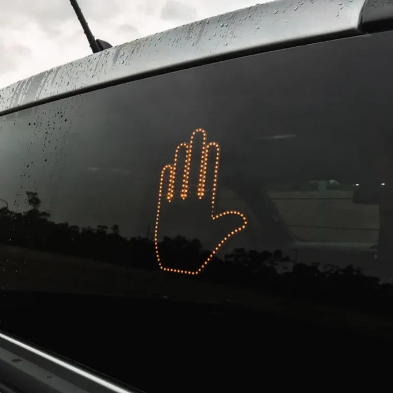 Black LED gesture car light with amber illumination showing hand gesture, remote control, and 3M Velcro mounting