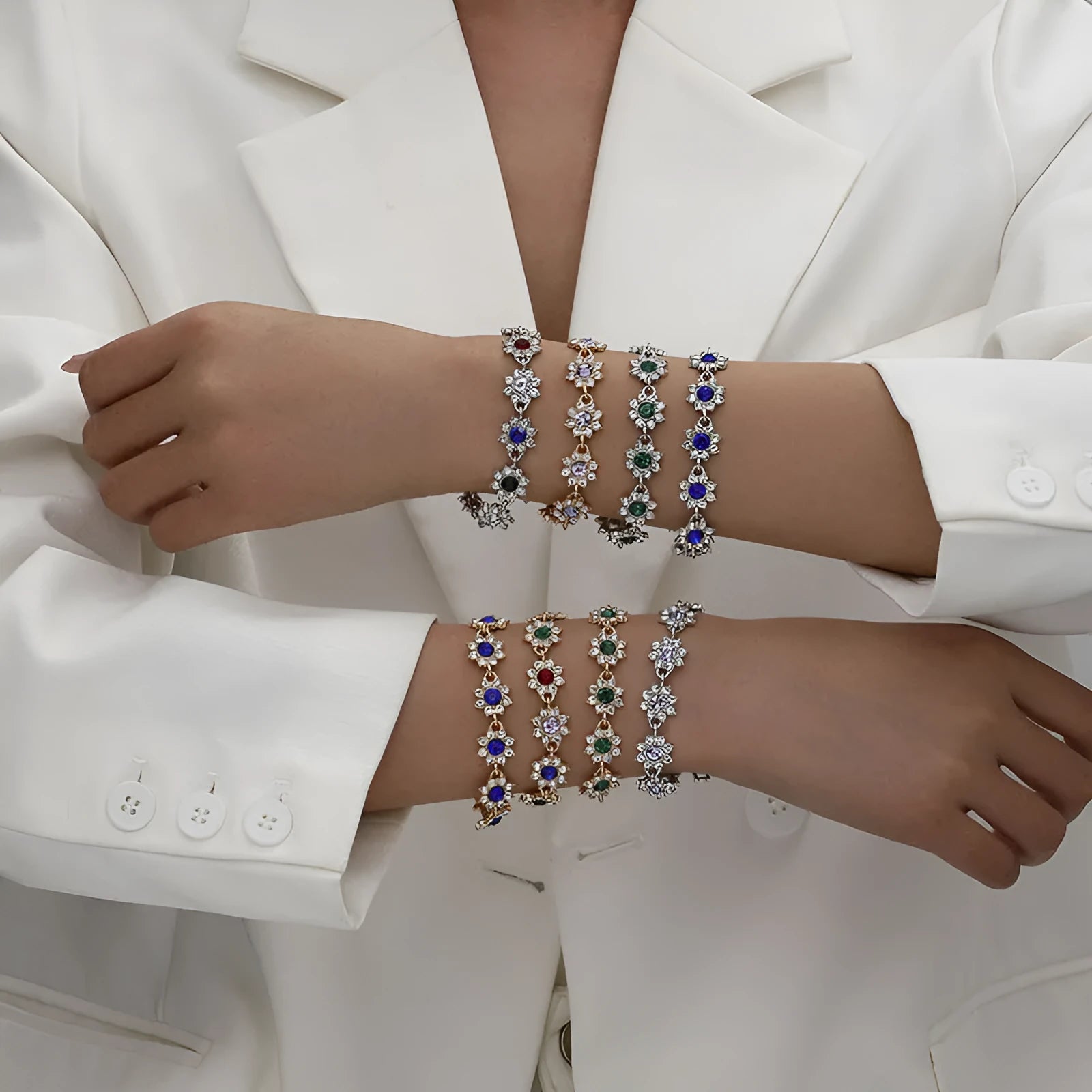 Electroplated zinc alloy flower bracelet with coloured crystals in gold or silver finish.