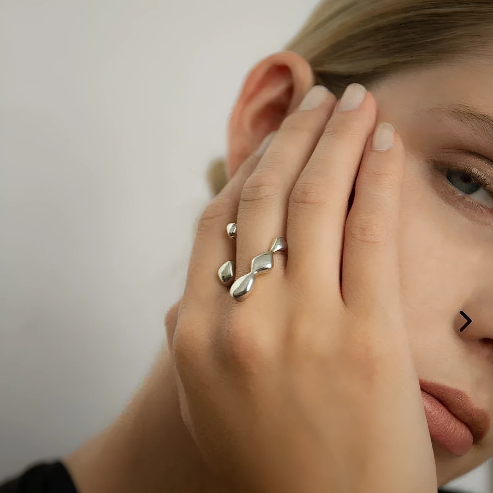 Adjustable brass ring with sphere design in gold or silver plating.
