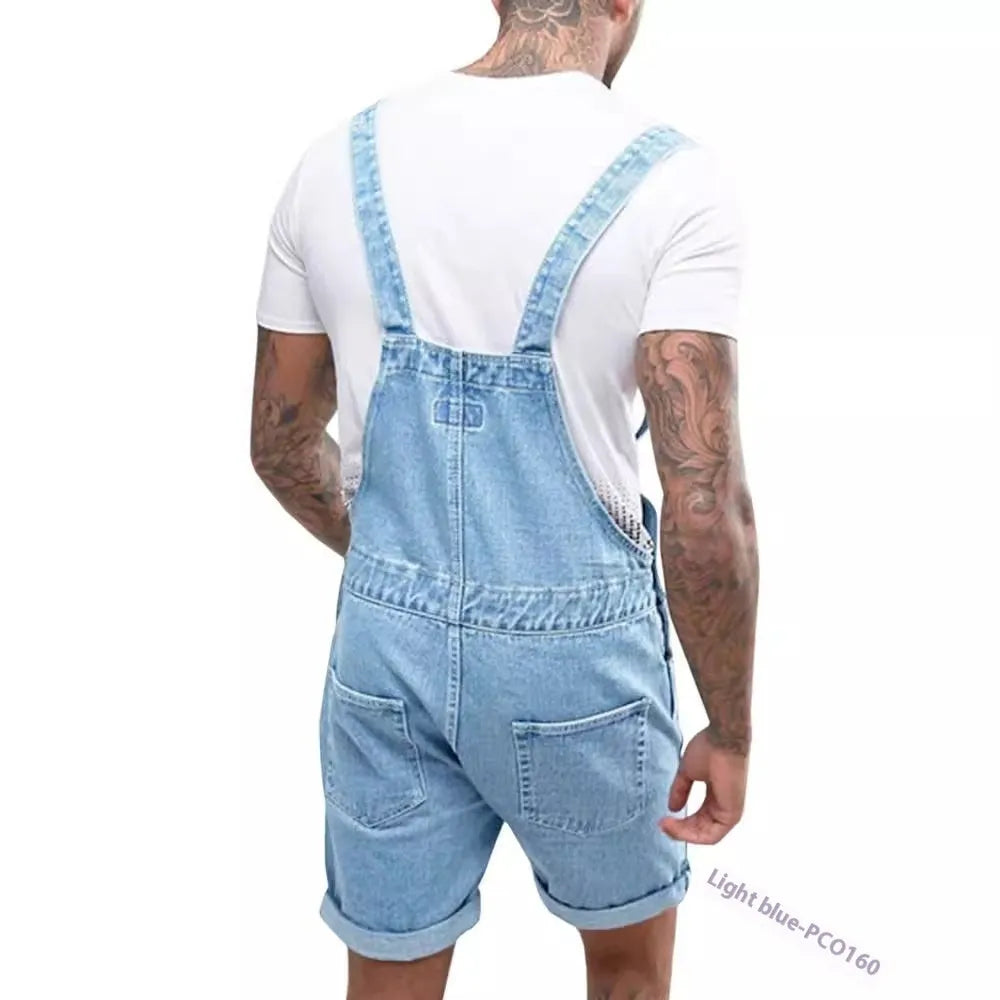 Male model wearing black mid-stretch denim suspender pants with straight leg cut and zip fly