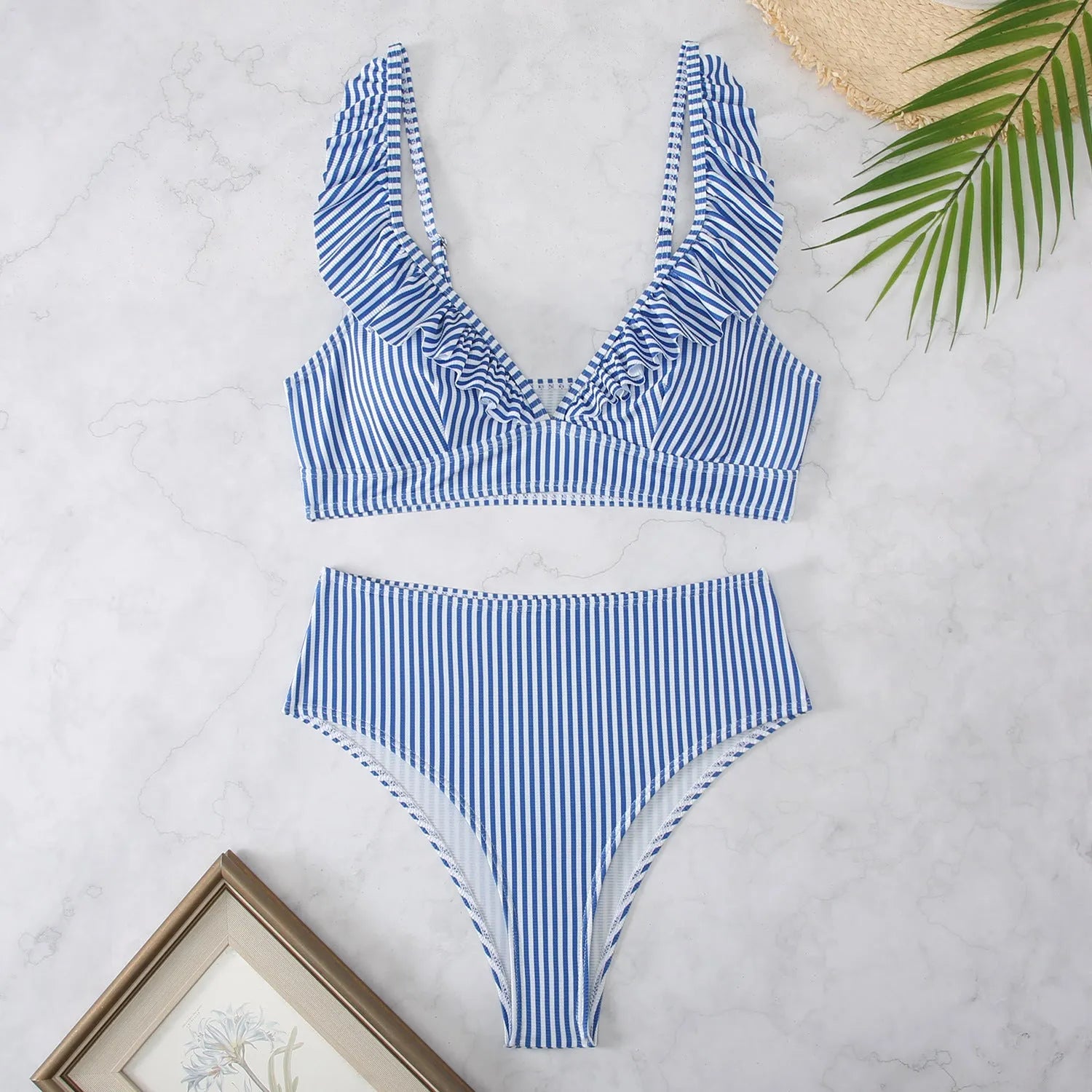 Women's black and white striped bikini with split chest design on a mannequin.