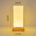 Nordic solid wood USB table lamp with touch control in geometric shapes on wooden surface