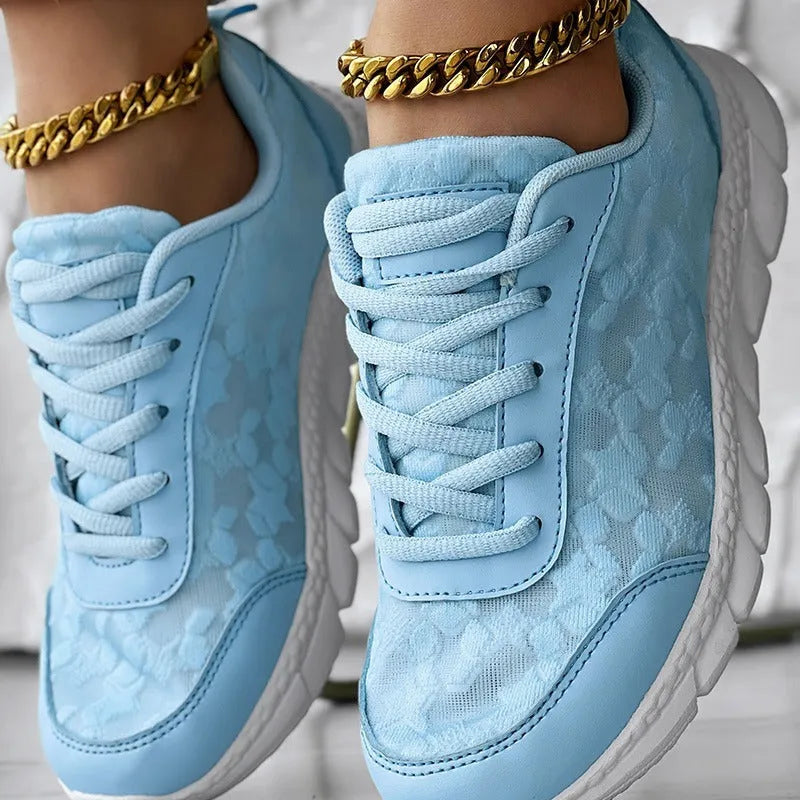 Women's white canvas running shoes with flat heel and round toe design on neutral background