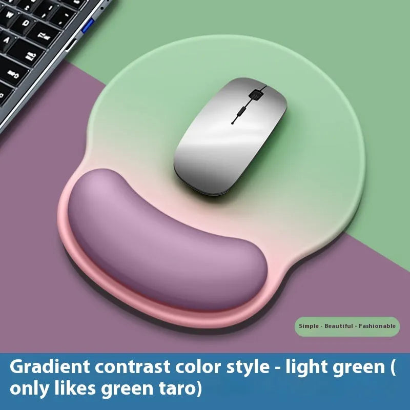 Silicone mouse mat with wrist support in a gradient blue colour on a desk.