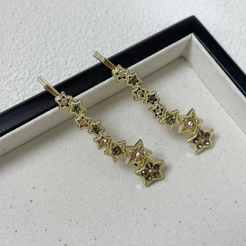 Gold-coloured alloy hair barrette with rhinestone, star, and word decoration in Korean style.