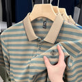 A man wearing a red striped casual short sleeve shirt with mosaic pattern detail.
