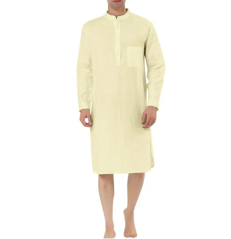 A man wearing a dark blue cotton shirt-style full-length robe for loungewear.