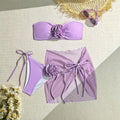 Women's pink tube top swimsuit with large 3D tied flower, matching skirt and pants.