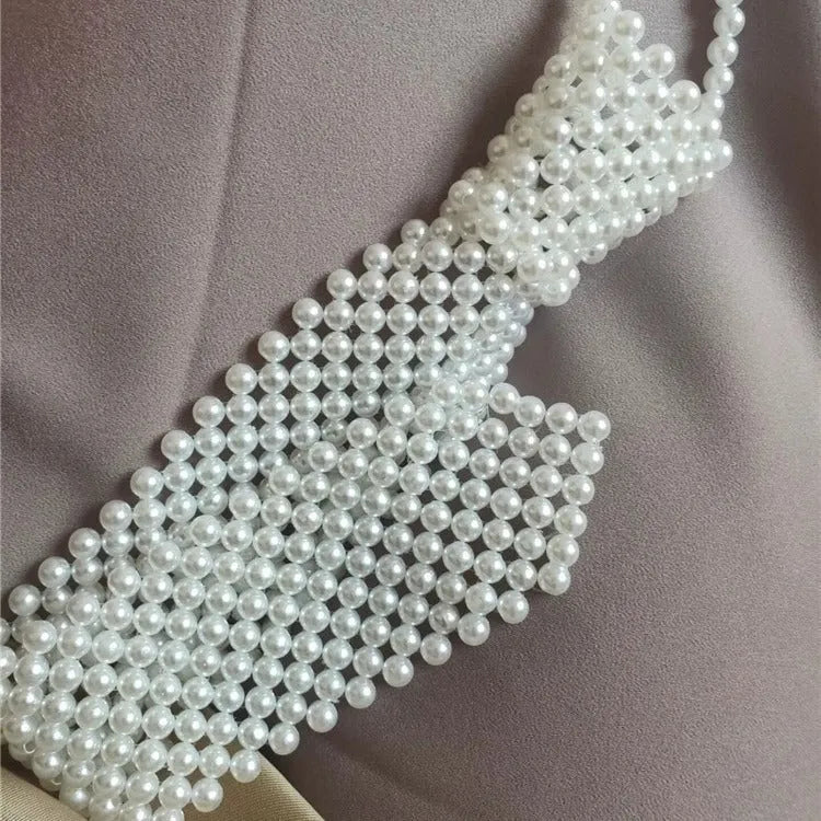 Women's pearl tie body chain with hollow-out design in white or black colour.
