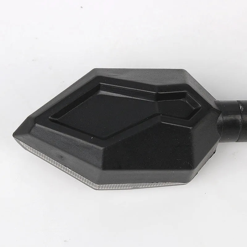 Arrow-shaped LED motorcycle turn signal light with ABS plastic housing for 12V systems.