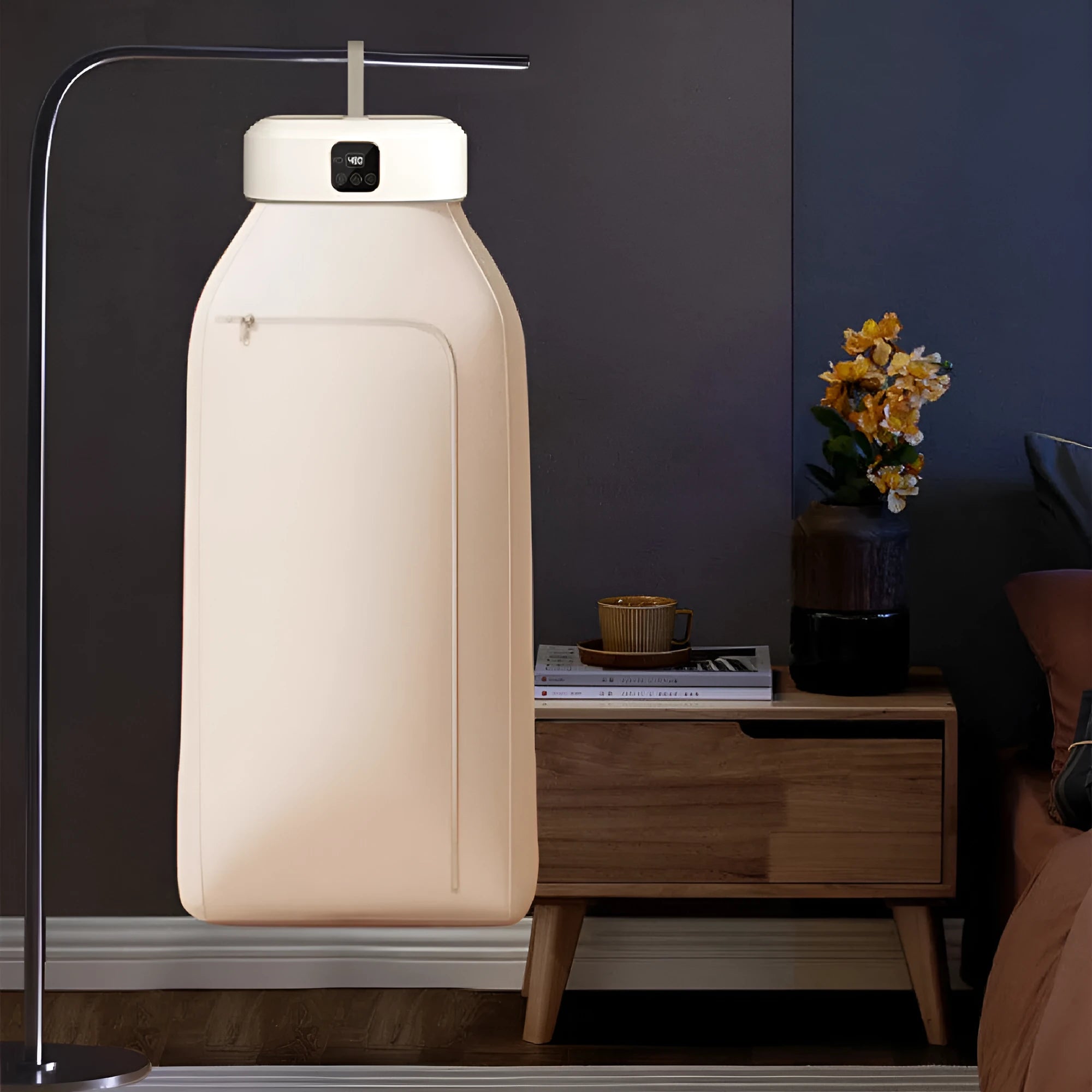 White cylindrical portable clothes dryer with remote control folded for storage